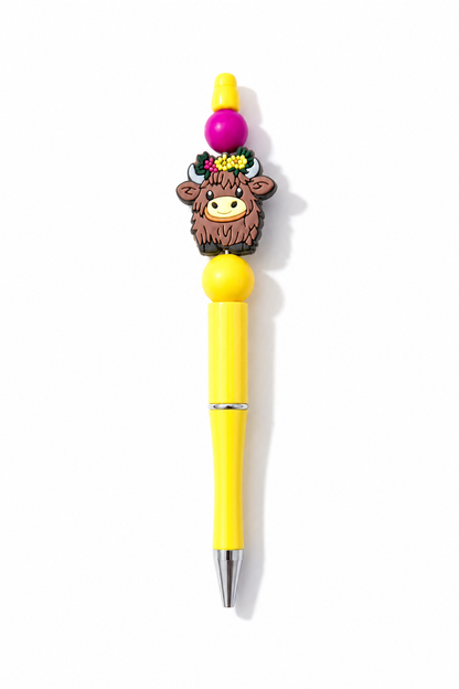 Highland Cow Beaded Pens in everyday writing use